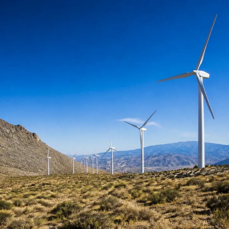A mountain wind farm across a highland valley